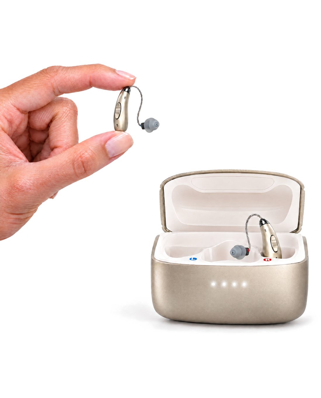 A hand holding one Clarion Clarity S3 hearing aid between finger and thumb to show its true size, beside the open charging case with the other aid inside.